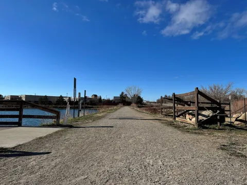 The gravel path along Erie Lake, running between the water and a split-rail fence