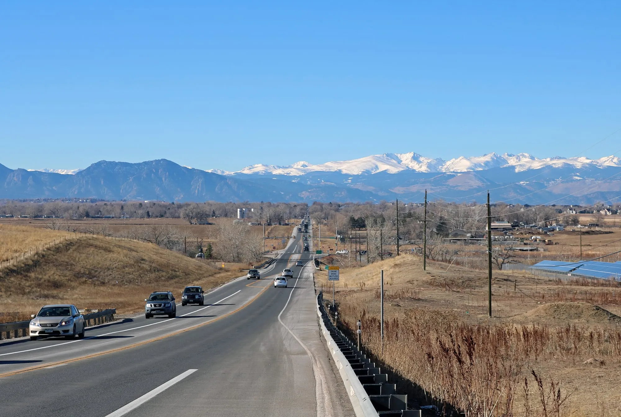 Colorado 7 running west out of Erie toward the snow-covered Front Range on a December morning