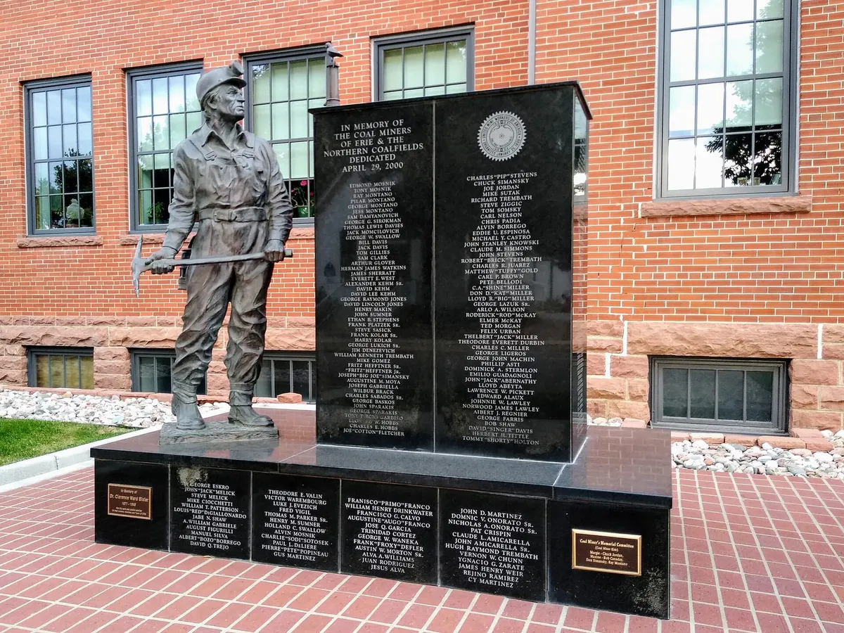 The bronze coal miner of the Erie Coal Miners' Memorial, with the names of more than 500 miners on black granite behind him