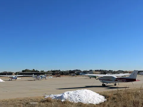 Light aircraft parked along the runway at Erie Municipal Airport
