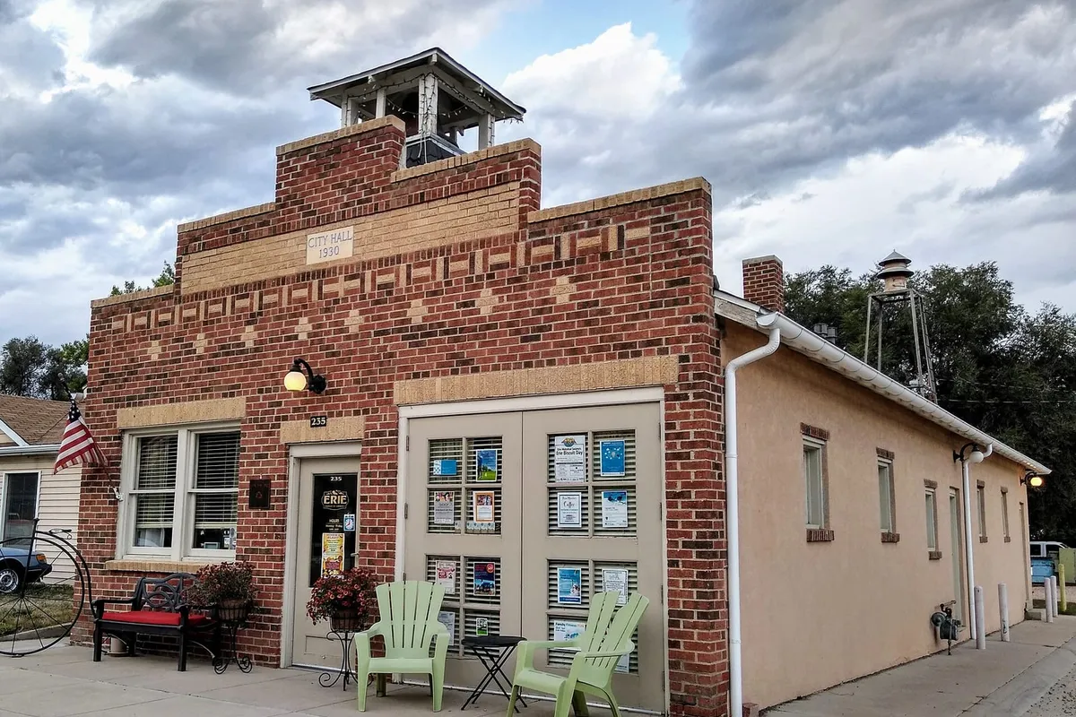 The 1930 Erie City Hall, a small brick building with a bell tower, now a downtown storefront