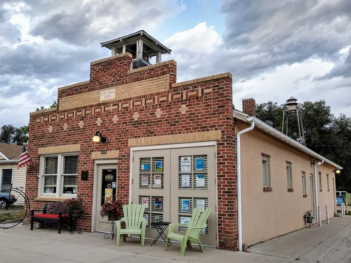The 1930 Erie City Hall, a small brick building with a bell tower, now a downtown storefront