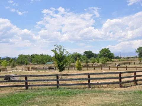 The Boneyard, the fenced dog park at Reliance Park, with the plains beyond the rails