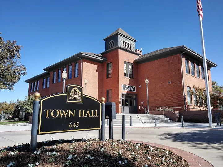 Erie Town Hall in the red-brick 1906 Lincoln School, with its bell tower